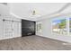The main bedroom features a barn door and black accent wall with fireplace feature at 73 Clyde Pearce Rd, Zebulon, NC 27597