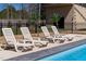 An outdoor pool is surrounded by lounge chairs and palm trees for a luxurious experience at 73 Clyde Pearce Rd, Zebulon, NC 27597