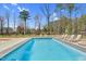 An outdoor pool with lounge chairs and landscaped surroundings, perfect for relaxation at 73 Clyde Pearce Rd, Zebulon, NC 27597