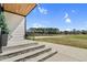 Inviting porch with stone steps, modern lighting, and views of the surrounding landscape at 73 Clyde Pearce Rd, Zebulon, NC 27597