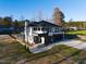 Modern home aerial view featuring sleek design, an in-ground pool, and black framed windows at 73 Clyde Pearce Rd, Zebulon, NC 27597