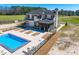 Aerial of home, pool, and patio featuring lounge seating and outdoor space at 73 Clyde Pearce Rd, Zebulon, NC 27597