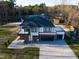 Aerial view of modern home showcasing roof, large driveway, and ample outdoor space at 73 Clyde Pearce Rd, Zebulon, NC 27597