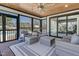 Cozy screened porch with wicker furniture, ceiling fan, and serene view at 73 Clyde Pearce Rd, Zebulon, NC 27597