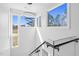Modern staircase with glass railings and a unique light fixture, offering bright views at 73 Clyde Pearce Rd, Zebulon, NC 27597