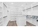 Large walk-in closet with custom shelving, hanging rods, and central island at 73 Clyde Pearce Rd, Zebulon, NC 27597