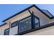 A window with black trim shows light fixtures in the rooms of this new home at 73 Clyde Pearce Rd, Zebulon, NC 27597