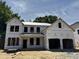 New construction two-story home showcasing its framing and architectural design elements in a suburban community at 740 Portland Rose Dr, Knightdale, NC 27545