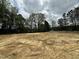 Cleared land showcasing the potential homesite nestled in a scenic location with mature trees and lush surroundings at 740 Portland Rose Dr, Knightdale, NC 27545
