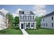 Charming two-story home featuring a welcoming front porch, well-manicured lawn, and classic architectural details at 755 Georgia'S Landing Pkwy # 116, Raleigh, NC 27603
