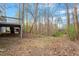 View of the backyard featuring a wooden deck and natural surroundings at 815 Riverbark Ln, Durham, NC 27703