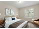 Cozy bedroom with a comfortable bed, natural light, hardwood floors and a calming ambiance at 815 Riverbark Ln, Durham, NC 27703