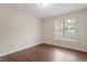 Empty bedroom featuring hardwood floors, a neutral color scheme, and ample natural light at 815 Riverbark Ln, Durham, NC 27703