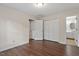 Empty bedroom with hardwood floors, a closet, ceiling light and access to ensuite bathroom at 815 Riverbark Ln, Durham, NC 27703