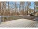 Wooden deck with railings overlooking a wooded area at 815 Riverbark Ln, Durham, NC 27703