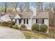 Charming single-Gathering home with a well-maintained lawn, complemented by a picket fence and lush landscaping at 815 Riverbark Ln, Durham, NC 27703