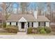 Charming single story home with light gray siding, black shutters, mature landscaping and a welcoming front entrance at 815 Riverbark Ln, Durham, NC 27703