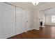 Hallway with closet space leading to a living area with a traditional fireplace at 815 Riverbark Ln, Durham, NC 27703