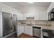 The kitchen offers stainless steel appliances, granite countertops, and white cabinetry at 815 Riverbark Ln, Durham, NC 27703