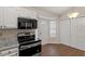 This eat-in kitchen features black appliances and ample storage space at 815 Riverbark Ln, Durham, NC 27703