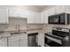 The kitchen features stainless steel appliances and granite countertops at 815 Riverbark Ln, Durham, NC 27703