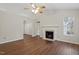 Spacious living room featuring hardwood flooring, a fireplace, ceiling fan and ample natural light at 815 Riverbark Ln, Durham, NC 27703