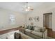 Bright and airy living room featuring a high ceiling, a fan, a modern sofa, and stylish decor at 815 Riverbark Ln, Durham, NC 27703