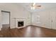 Bright and open living room featuring a fireplace, large windows, hardwood floors, and access to other rooms at 815 Riverbark Ln, Durham, NC 27703