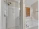 Bathroom featuring a walk-in shower with glass door and a separate soaking tub with jacuzzi jets at 9512 Anson Grove Ln, Raleigh, NC 27615