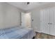 Neutral bedroom featuring wood-look floors, double closets, and an en suite bathroom at 9512 Anson Grove Ln, Raleigh, NC 27615