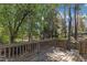 Large wooden deck with railing, overlooking the backyard and mature trees; great for outdoor relaxing at 9512 Anson Grove Ln, Raleigh, NC 27615