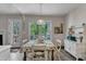 Bright dining area features a wooden table, a window with a view, and a door to the outside at 9512 Anson Grove Ln, Raleigh, NC 27615