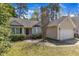 Inviting single-story home with a well-maintained yard, lovely landscaping and an attached two-car garage at 9512 Anson Grove Ln, Raleigh, NC 27615