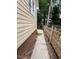 Side view of home with vinyl siding, a pathway, and a wooden fence at 9512 Anson Grove Ln, Raleigh, NC 27615