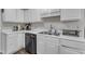 The kitchen features bright white cabinets, stainless steel appliances, and ample counter space for cooking and entertaining at 9512 Anson Grove Ln, Raleigh, NC 27615