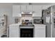 A bright kitchen features white cabinets, stainless steel appliances, and ample counter space for cooking and entertaining at 9512 Anson Grove Ln, Raleigh, NC 27615