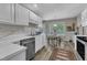 This well-lit kitchen features stainless steel appliances and connects to a bright breakfast area with a window view at 9512 Anson Grove Ln, Raleigh, NC 27615