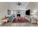 Open living room with a fireplace, wood-look floors, comfortable seating and natural light at 9512 Anson Grove Ln, Raleigh, NC 27615