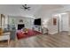 Spacious living room featuring a fireplace, wood flooring and large windows offering outdoor views at 9512 Anson Grove Ln, Raleigh, NC 27615