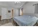 Spacious main bedroom featuring wood-look flooring, neutral paint, a ceiling fan, and en suite bathroom at 9512 Anson Grove Ln, Raleigh, NC 27615