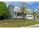 Inviting two-story home with a charming front porch, well-maintained lawn, and attached two-car garage at 1 Serenity Ct, Durham, NC 27704