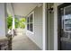 Cozy front porch detail showcasing a covered area with railing, perfect for enjoying the outdoors at 1 Serenity Ct, Durham, NC 27704