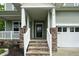 Welcoming front porch with stone pillars, white railing, and steps leading to the home's entrance at 1 Serenity Ct, Durham, NC 27704