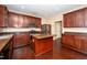 Well-equipped kitchen with dark wood cabinets, stainless steel appliances, and a functional center island at 1 Serenity Ct, Durham, NC 27704