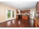 Open kitchen featuring stainless steel appliances, an island, and hardwood floors, perfect for cooking at 1 Serenity Ct, Durham, NC 27704