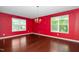 Bright room with hardwood floors, large windows, and a modern chandelier, creating an inviting space at 1 Serenity Ct, Durham, NC 27704