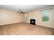Comfortable living room featuring plush carpeting, a ceiling fan, and a cozy fireplace at 1 Serenity Ct, Durham, NC 27704