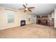 Spacious living room with a ceiling fan, fireplace, and an open floor plan to the kitchen at 1 Serenity Ct, Durham, NC 27704