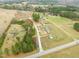 Sprawling aerial view of the property with multiple homes and a pond at 10 Chaney Ln, Louisburg, NC 27549