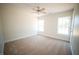 A bright, spacious bedroom featuring neutral carpet, and natural light from two windows at 10 Chaney Ln, Louisburg, NC 27549